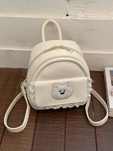 Stylish cream-colored mini backpack for women featuring lace trim and a cute plush bear patch