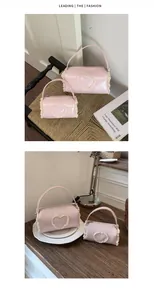 Details of pink cylindrical bags with lace heart patch on wooden and woven surfaces.