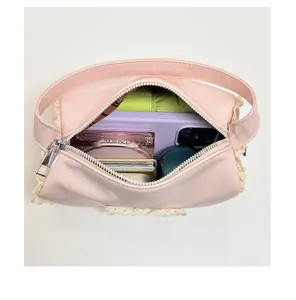 Top-down view of pink mini cylinder handbag showing interior space and lace details
