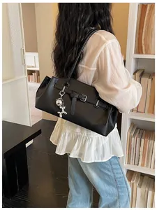 Stylish black pebbled leather shoulder bag with a cute silver balloon dog charm.