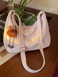 Stylish large pink faux leather shoulder bag for women with a cute plush mascot charm