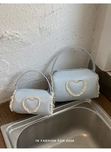 Detailed comparison of two light blue cylindrical handbags with lace hearts for women