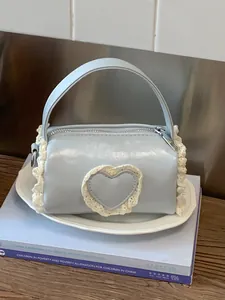 Stylish light blue mini cylindrical handbag featuring a cute lace heart detail for women