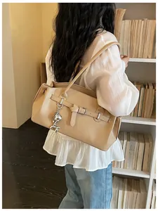 Chic beige pebble leather shoulder bag with balloon dog charm detail