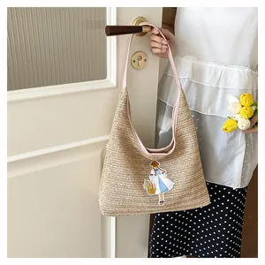 Handmade woven straw tote bag featuring cartoon girl embroidery for beach vacations