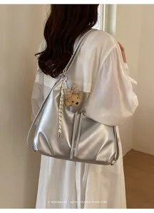 Vista dettagliata di un'elegante borsa argento capiente indossata da una modella