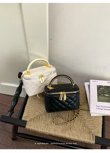 High-quality quilted leather vanity box bags in black and white with gold chain straps