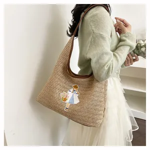 Large handwoven straw tote bag with cute embroidery detail for summer beach vacation