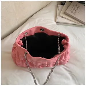 Detailed interior view of pink ruched tote bag featuring chain straps and magnetic snap