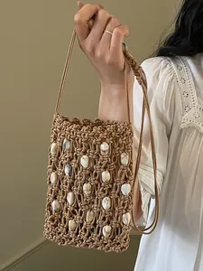 Bolso bandolera de paja tejido a mano con conchas para vacaciones de verano y playa