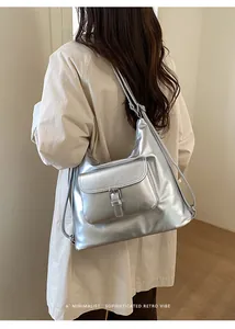Back view of a stylish model carrying a large silver metallic multi-functional tote bag