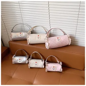 Trendy mini cylindrical handbags in pink, white, and silver with cute ruffle edges.