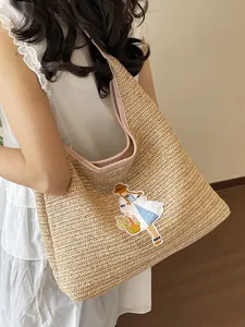 Large handmade woven straw tote bag featuring a cute girl embroidery patch detail.