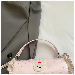 Close-up of pink polka dot mini handbag featuring a cute white bear and ruffle design