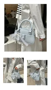 Elegant light blue small handbag featuring lace pearl bow charm for stylish women