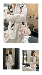 Elegant pink small handbag for women with a delicate lace bow and pearl charm detail.