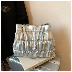 Silver metallic pleated tote bag with chain strap and large capacity shown in detail