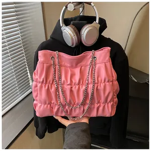 Detailed view of the pink pleated tote bag with silver chain strap for students.