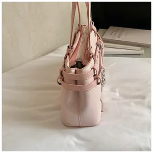 Side view of a light pink elegant women's underarm tote bag with silver hardware