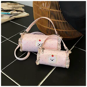 Pink cylindrical mini handbags with cute bear pattern and ruffle trim details