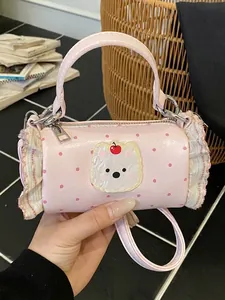 Stylish mini pink polka dot handbag with cute bear patch and elegant ruffle details