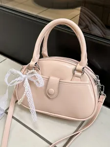Elegant pink semi-circle handbag featuring a delicate lace bow and pearl decoration