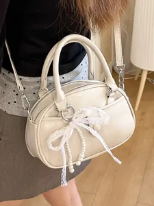 Elegant cream patent leather handbag with lace bow and pearl detail crossbody bag