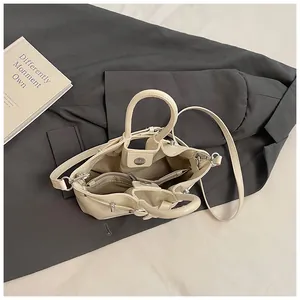Detailed top view of beige tote bag showing internal zipper compartment and straps
