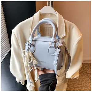 Stylish light blue crossbody handbag with elegant pearl lace charm detail for women