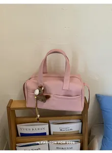 Detailed macro view of the pink large capacity pillow bag featuring a cute horse charm