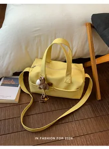 Stylish large capacity yellow pebble leather Boston bag with a cute horse charm strap