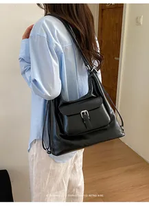 Back view of a stylish black large capacity multifunctional tote bag worn on shoulder