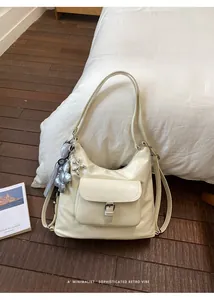 Detail view of cream white retro vibe multifunctional shoulder bag on wooden floor