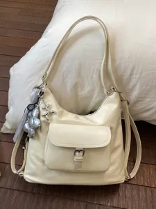 Elegant creamy white multi-functional hobo bag with front pocket and decorative charms