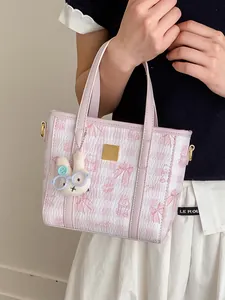 Fashionable pink and white checkered handbag for women with a cute plush bunny charm