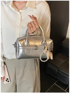 Silver metallic wrinkled Boston pillow bag featuring decorative buckle strap and pearl charm
