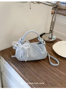Elegant light blue polka dot dumpling bag with lace bow and pearl chain detailing