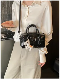 Sophisticated black glossy faux leather Boston bag with cute horse charm detail