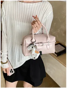 Stylish light pink Boston pillow bag for women with a decorative cute puppy charm