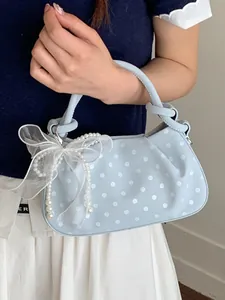 Elegant light blue polka dot dumpling handbag with white pearl bow decoration for women