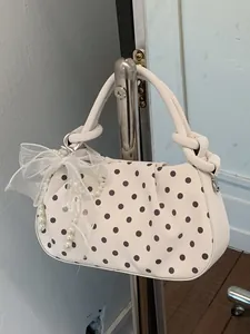 Elegant white polka dot dumpling handbag with bow and pearl detail for women