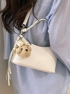 Elegant white underarm shoulder bag featuring a cute teddy bear charm and soft bow