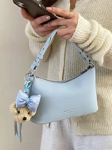 Elegant light blue underarm shoulder bag for women featuring a cute teddy bear charm