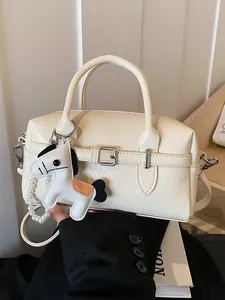 Stylish cream-colored women's Boston bag featuring a horse charm with pearl strap detail
