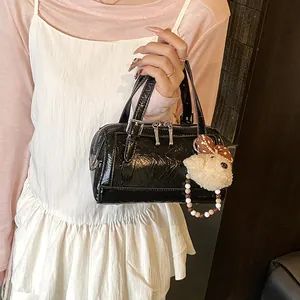 Elegant retro black patent leather Boston bag with cute plush bear keychain charm