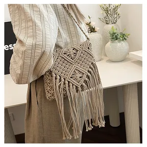 Detailed view of a hand-woven macrame crossbody bag with long tassels and fringe