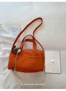 Orange large capacity tote bag with crossbody strap and horse charm on white background