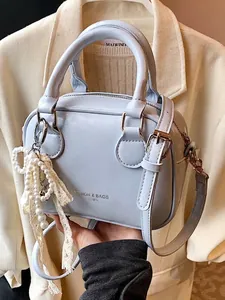Elegant light blue women's crossbody handbag with pearl charm for spring 2026 fashion