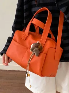Stylish large capacity orange faux leather pillow tote bag with wide strap and charm
