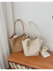 Two vintage woven tote bags with teddy bear charms on a wooden table scene